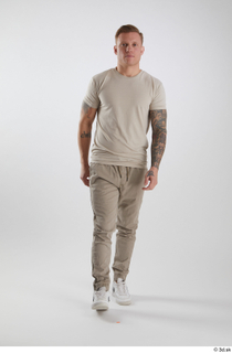 Gilbert 1 dressed front view grey t-shirt grey trousers walking…